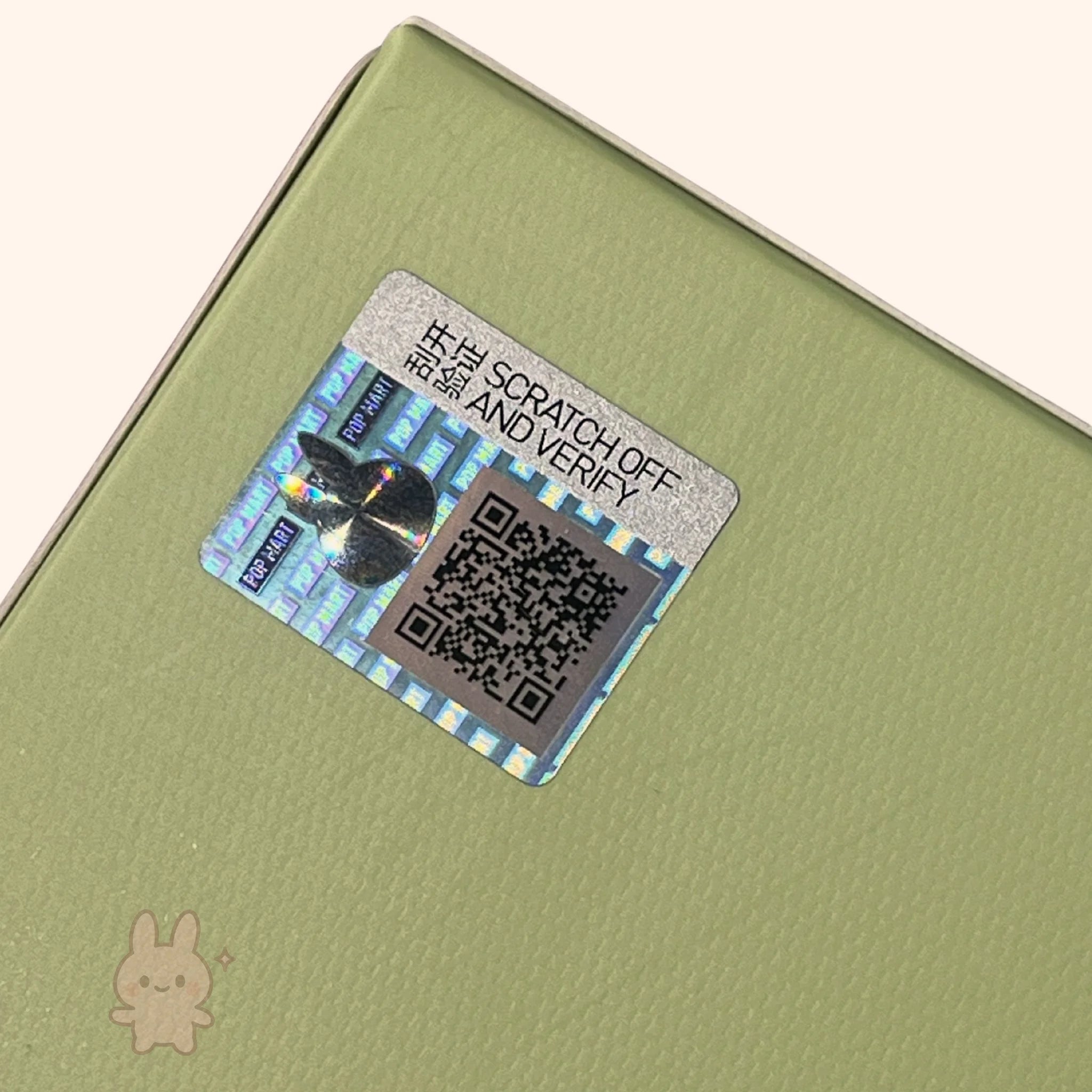 Labubu – Exciting Macaron Vinyl Face – security label with QR code on a green surface