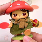 pucky faries market Toy figure with a red mushroom hat held by a hand against a colorful background