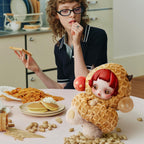 Tan You Found Me plush character in a kitchen scene