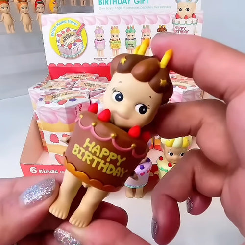 Sonny Angel Birthday Gift Chocolate Cake figure held in hand in front of the display box