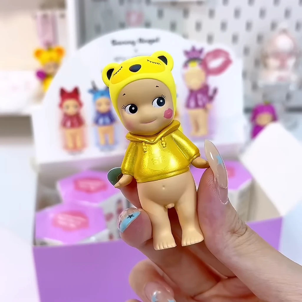 Sonny Angel x shu uemura Solar Tanuki figure with yellow tanuki headpiece and metallic gold hoodie, held in hand