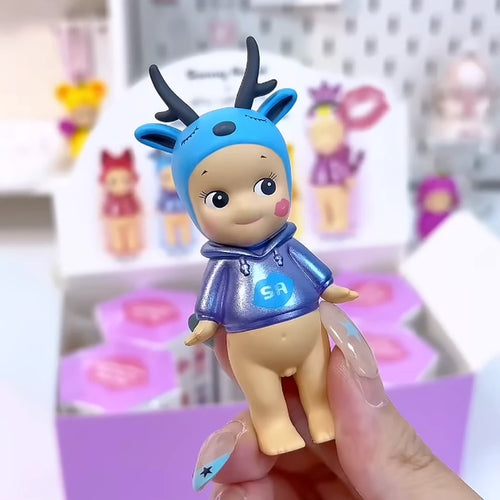 Sonny Angel x shu uemura Zen Deer figure with blue antler headpiece and metallic blue hoodie, held in hand