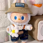 Labubu Toy figure with a hat and overalls holding a flower, standing next to a wooden object.