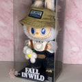 Labubu Toy figure in a box with 'Fall in Wild' branding, wearing a hat and overalls.
