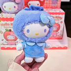 hello kitty Blue plush toy with a hood held in front of Hello Kitty boxes