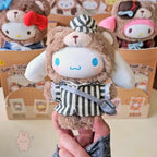 sanrio-afternoon Plush toy with a striped outfit held in front of a box with more plush toys in the background.