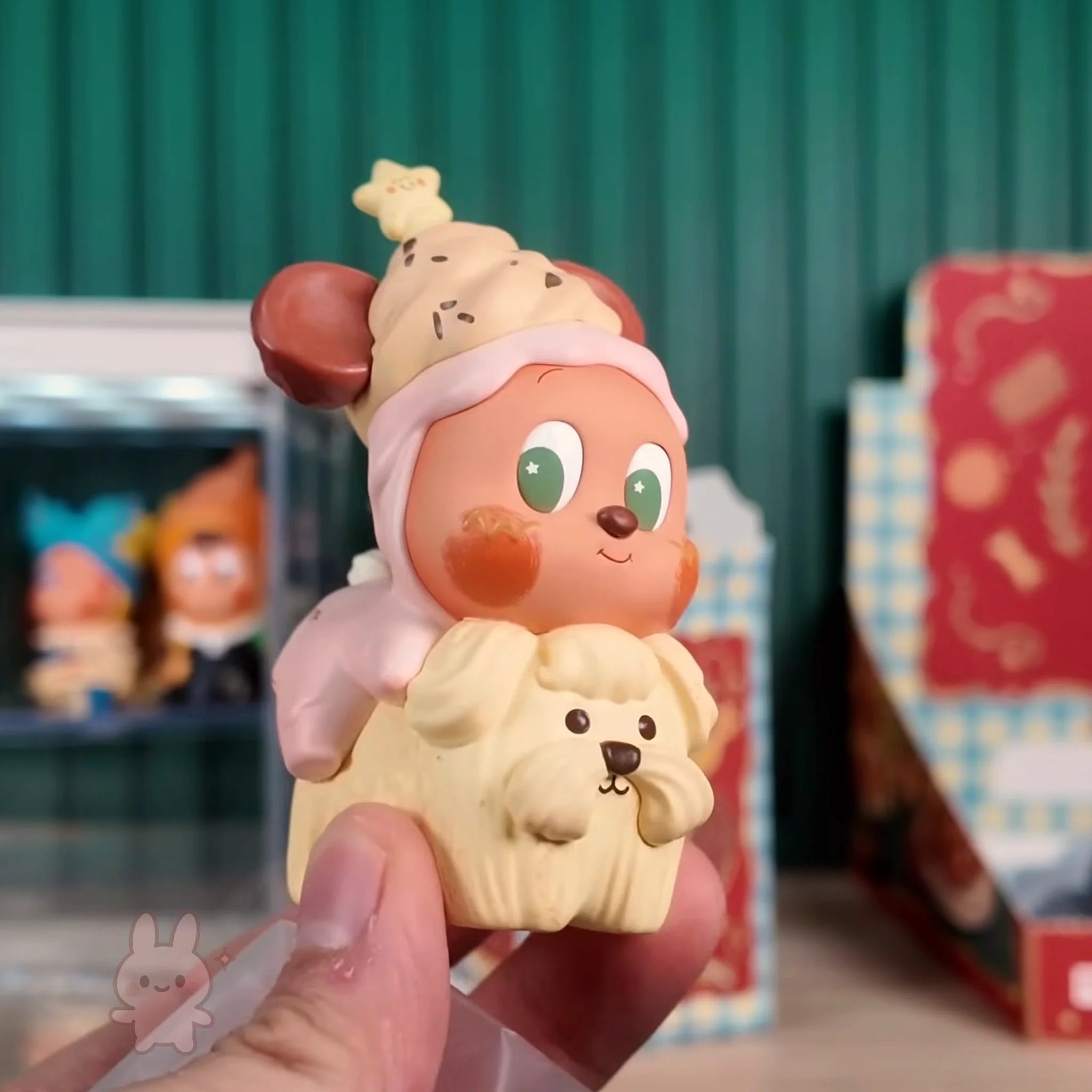 Twinkle Twinkle Savor the Moment Toy figure of a character with a dog on its back, held in front of a store display.