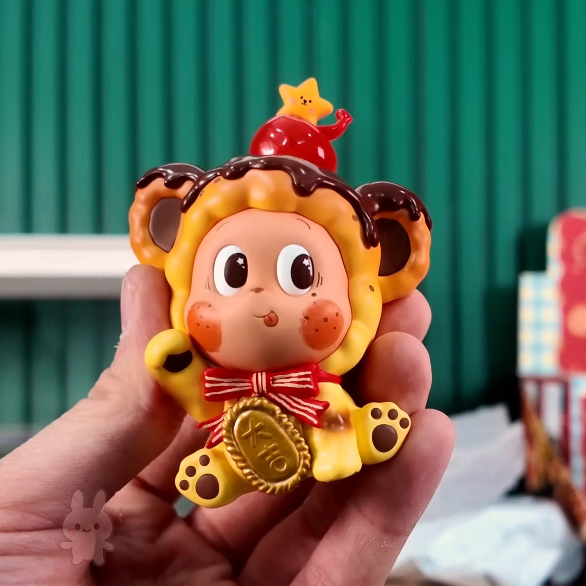 Twinkle Twinkle Savor the Moment Toy lion figure with a star on its head held in a hand against a blurred background